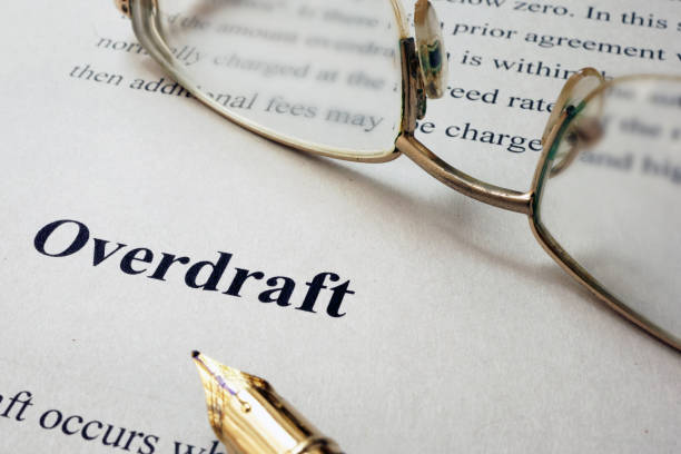 istock Page of paper with words Overdraft and glasses. 686380498