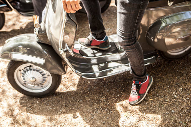 istock Young man riding old style scooter 686383498