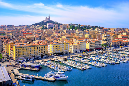 The old Vieux Port and Basilica Notre Dame de la Garde in the historical city center of Marseilles, France