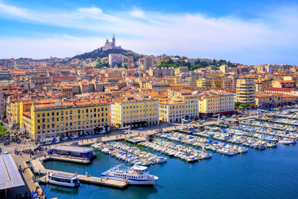 View of the historical old town of Marseilles, France The old Vieux Port and Basilica Notre Dame de la Garde in the historical city center of Marseilles, France marseille stock pictures, royalty-free photos & images