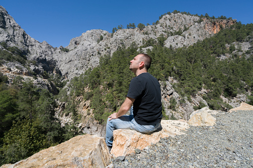 The Turkish man is looking at the mountains in the göğnük canyon in Antalya, Kemer.