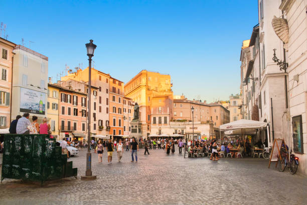 Campo de' Fiori full of Tourists and Statue of Giordano Bruno at Sunset, Rome, Italy. stock photo