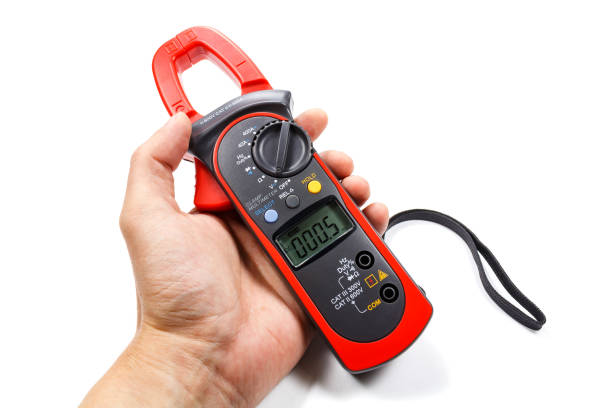 istock Digital clamp multimeter in man's hand on a white background 686409746