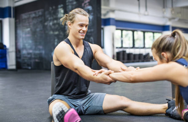 A couple excercising on a mat