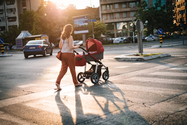 istock Pedestrians with baby prams in traffic 686413128