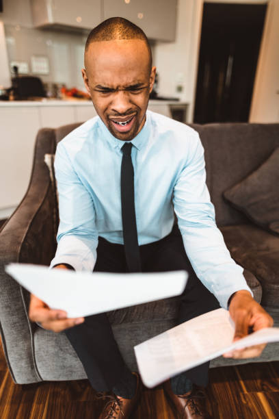 istock businessman reading rading the bills at home 686415492