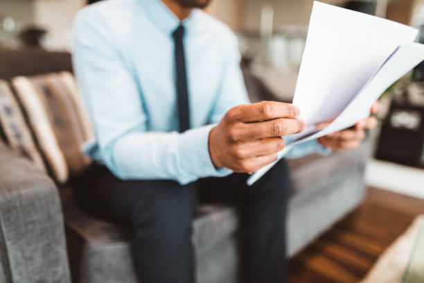 istock businessman reading rading the bills at home 686415516