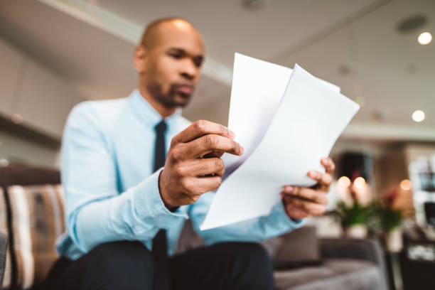 businessman reading rading the bills at home