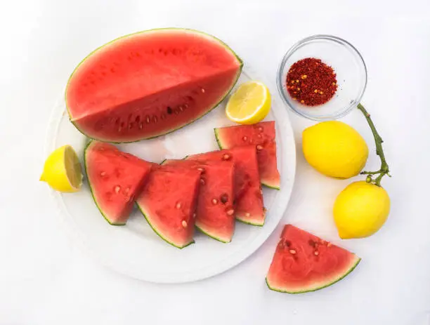 Mexican combination of  watermelon, lemons and pepper flecks on a white background.