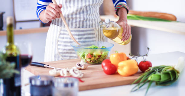 istock Young woman mixing fresh salad 686424050