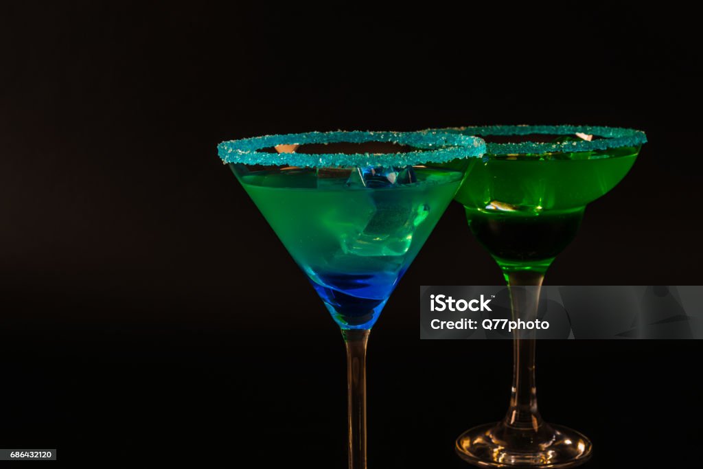 Colorful drink in a cocktail glass, with ice cubes, summer drink Colorful drink in a cocktail glass, with ice cubes, summer drink, party night Alcohol - Drink Stock Photo