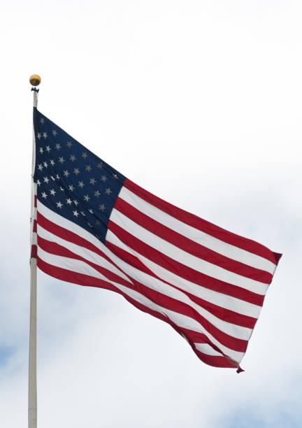 American flag waiving on a wind outside on a cloudy day