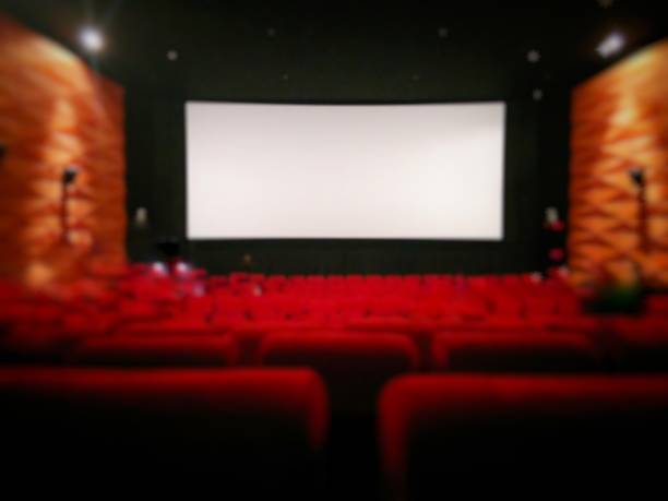 istock blurred of cinema screen with red seats 686458656