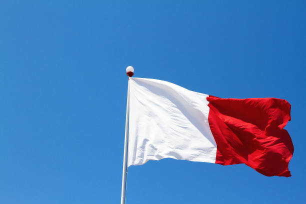 istock Flag of Malta Flies Against Vibrant Blue Sky, Copy Space 686475304