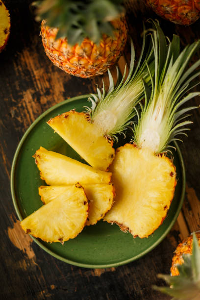 Sliced Pineapple on Wooden Background stock photo