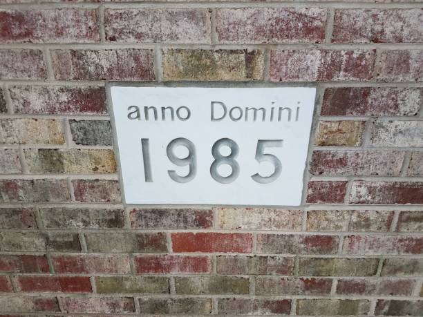 Anno Domini 1985 Sign On Brick Wall Stock Photo - Download Image