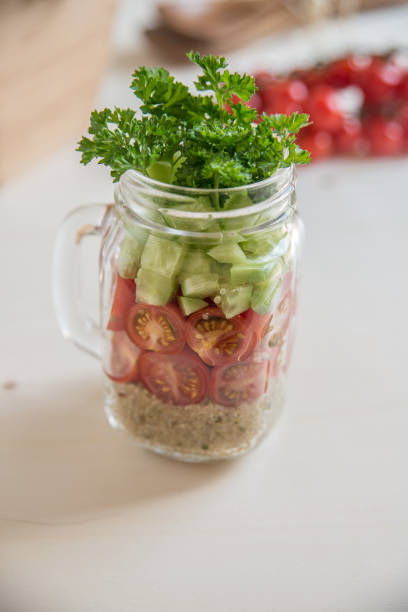 istock Quinoa salad in a glass with vegetables 686477932