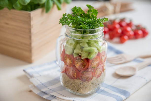 istock Quinoa salad in a glass with vegetables 686477992
