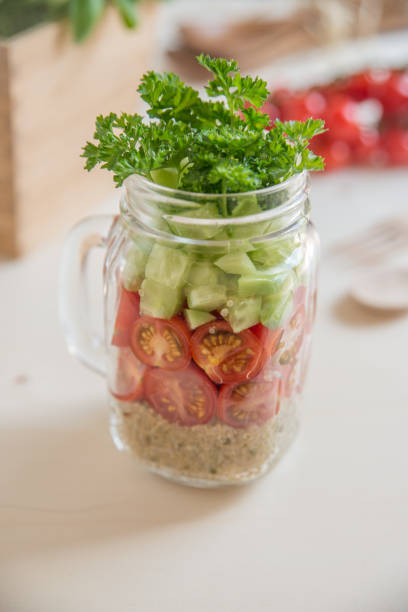 istock Quinoa salad in a glass with vegetables 686478410