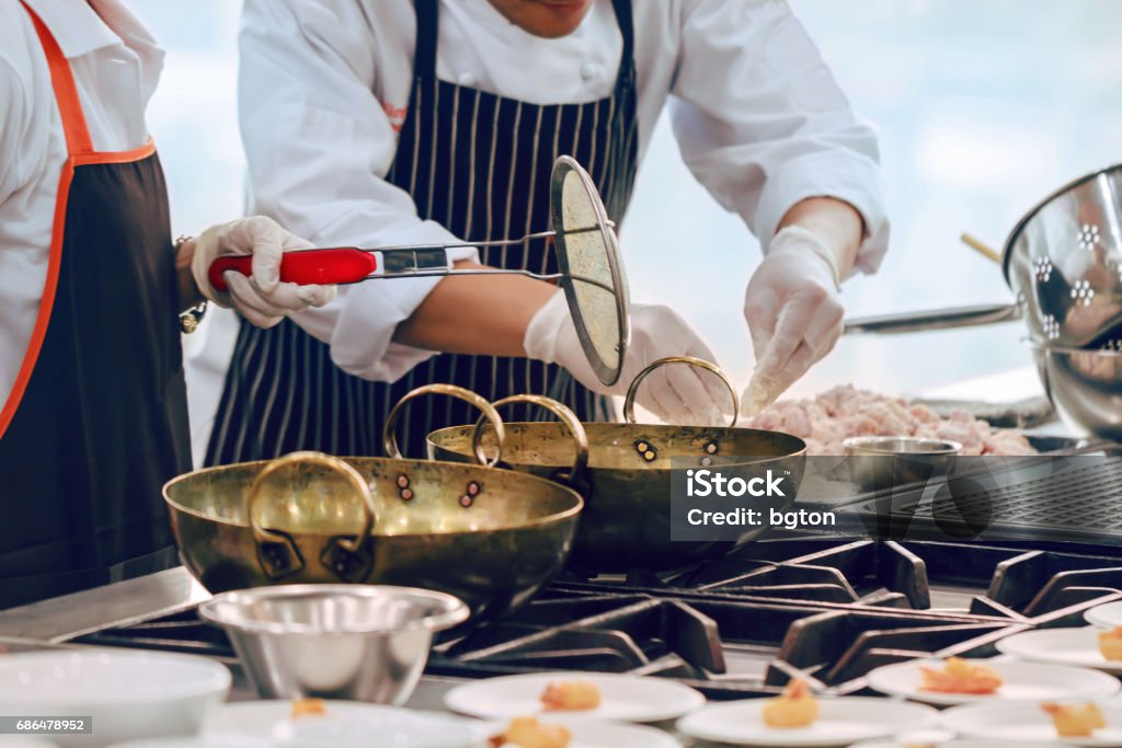 Busy cooking Busy cooking of chefs in restaurant kitchen Cooking Stock Photo