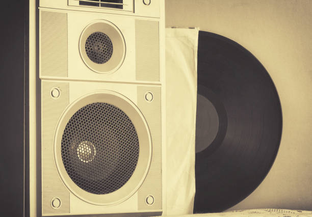 istock Old music speaker in foreground, record in paper cover 686479016