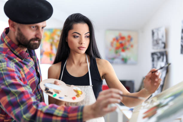 istock Male painter and female apprentice working in atelier 686488348
