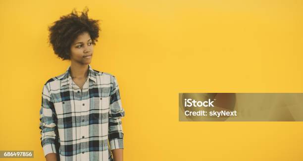Black Girl With Copy Space On Yellow Background Stock Photo - Download Image Now - Teenager, African-American Ethnicity, Solid