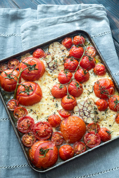 istock Fresh tomatoes, feta, garlic and thyme on the tray 686501146
