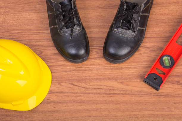 istock Top view safety shoes and composition of working tools 686505332