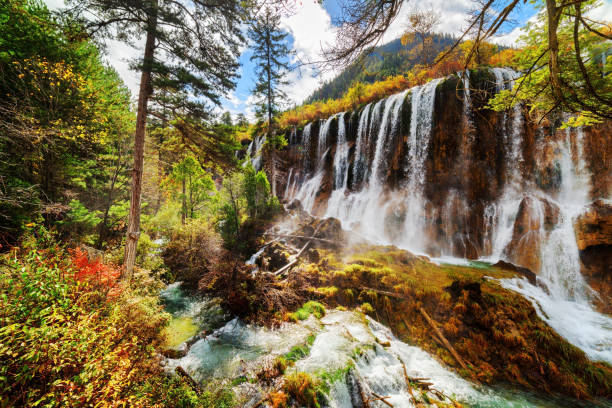 istock The Nuo Ri Lang Waterfall (Nuorilang) among colorful fall woods 686508654