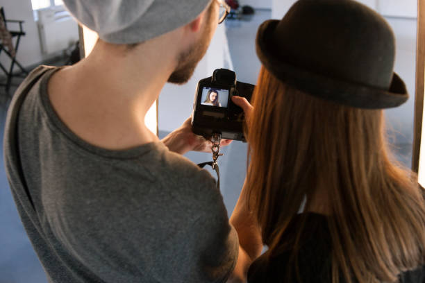 istock Photographer and model watching photos on camera 686522488