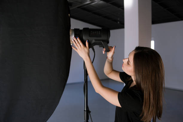 istock Assistant of photographer adjust light in studio 686522526