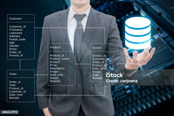 Double Exposure Of Professional Businessman Hold Database Table With Server Storage And Network In Datacenter Background Stock Photo - Download Image Now