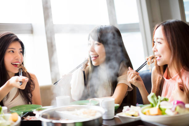 istock happy young Women group  Eating hot pot 686525152
