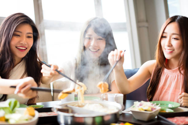 happy young Women group  Eating hot pot