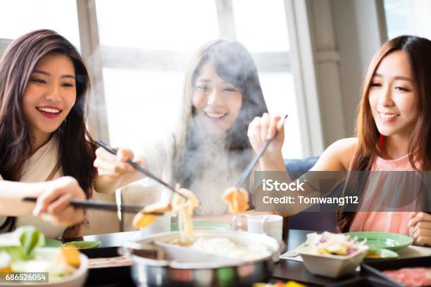 Happy Young Women Group Eating Hot Pot Stock Photo - Download Image Now - Eating, Hot Pot - Dish, Chinese Ethnicity