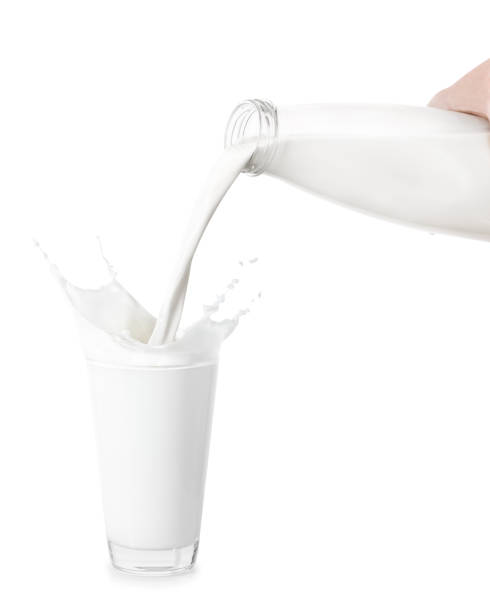 istock milk from bottle pouring into glass 686529470