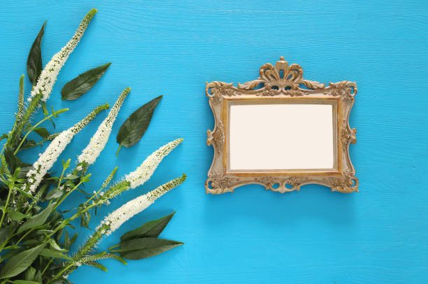 istock spring beautiful white flowers and blank victorian photo frame 686539932
