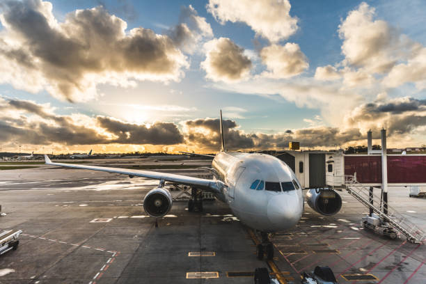 istock Airplane boarding passengers at airport at sunset 686543568