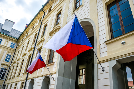 State flags of the Czech Republic at the entrance to the building of the President of the Czech Republic