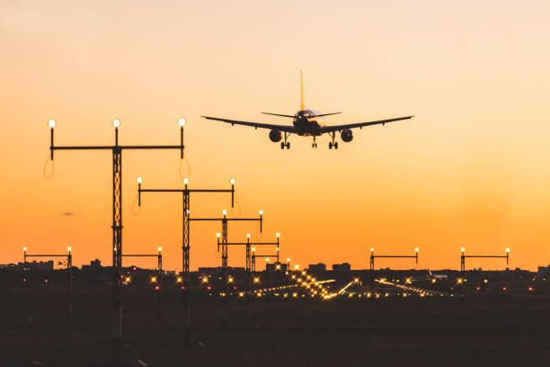 istock Airplane landing at sunset, silhouette 686546454