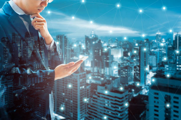 istock Double exposure of professional businessman connected internet and wireless network with his smart phone and city of business background in business trading and technology concept 686559232
