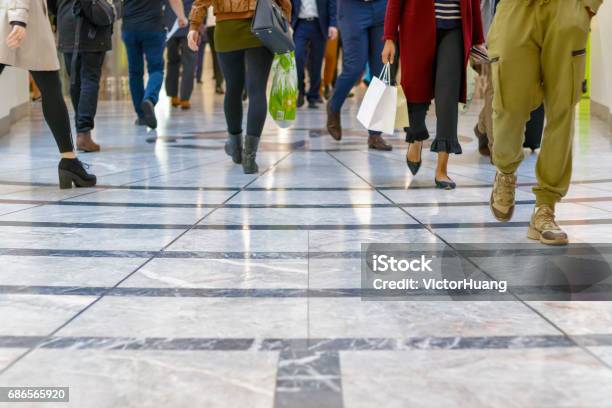 A Modern Floor With Legs Of A Crowd Walking In The Background Stock Photo - Download Image Now