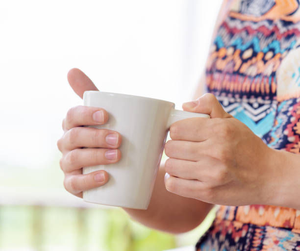istock Young woman enjoying a mug of beverage. 686569672