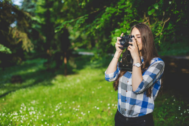 istock Young beautiful girl with old camera 686578446