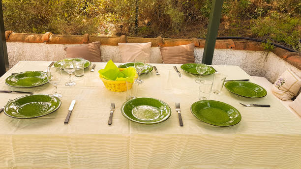 istock Green dishes on table ready for food to be served on a formal lunch time. 686582144