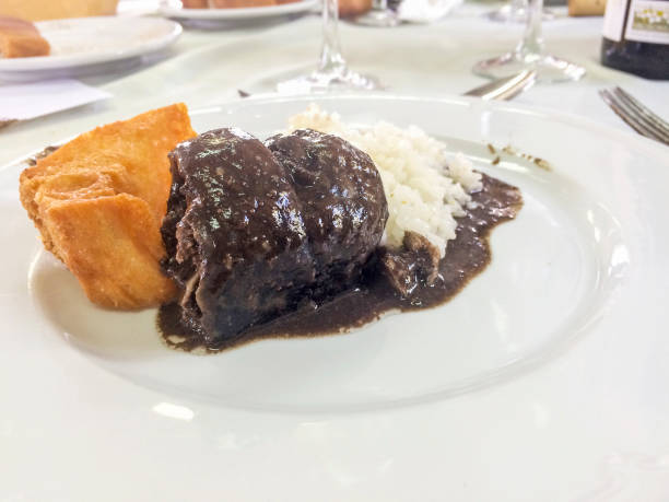 istock Lamprey in bordeaux sauce with rice and croutons 686582246