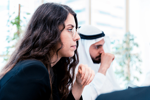 Female business leader attending a business meeting with Emirati Businessman