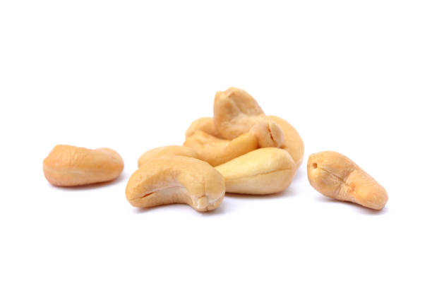 Roasted salted cashews Roasted salted cashews isolated on a white background cashew photos stock pictures, royalty-free photos & images