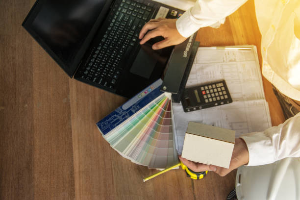 istock architect  working with laptop ,model and blueprints on wood table,  vintage stlye color 686601028